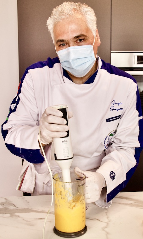 giorgio giorgetti di cucino di te lavora con guanti e mascherina per la sicurezza del cliente